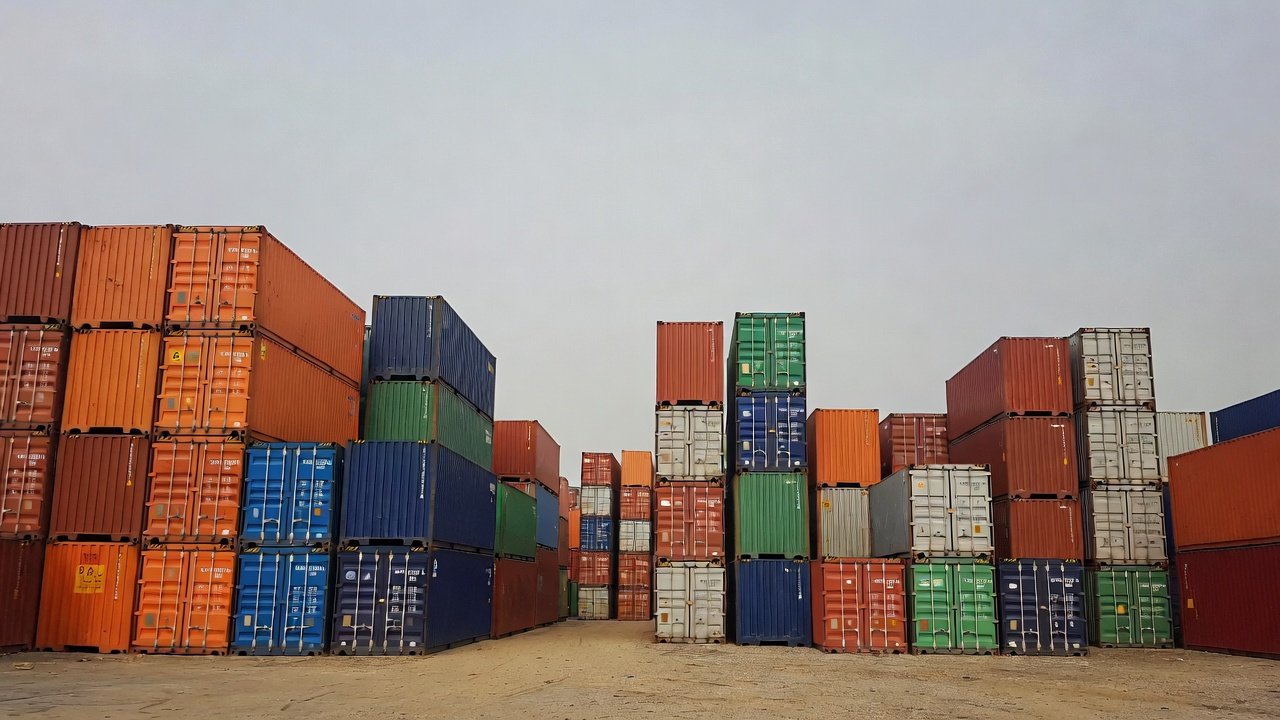 Shipping containers and portable storage units compared at a depot